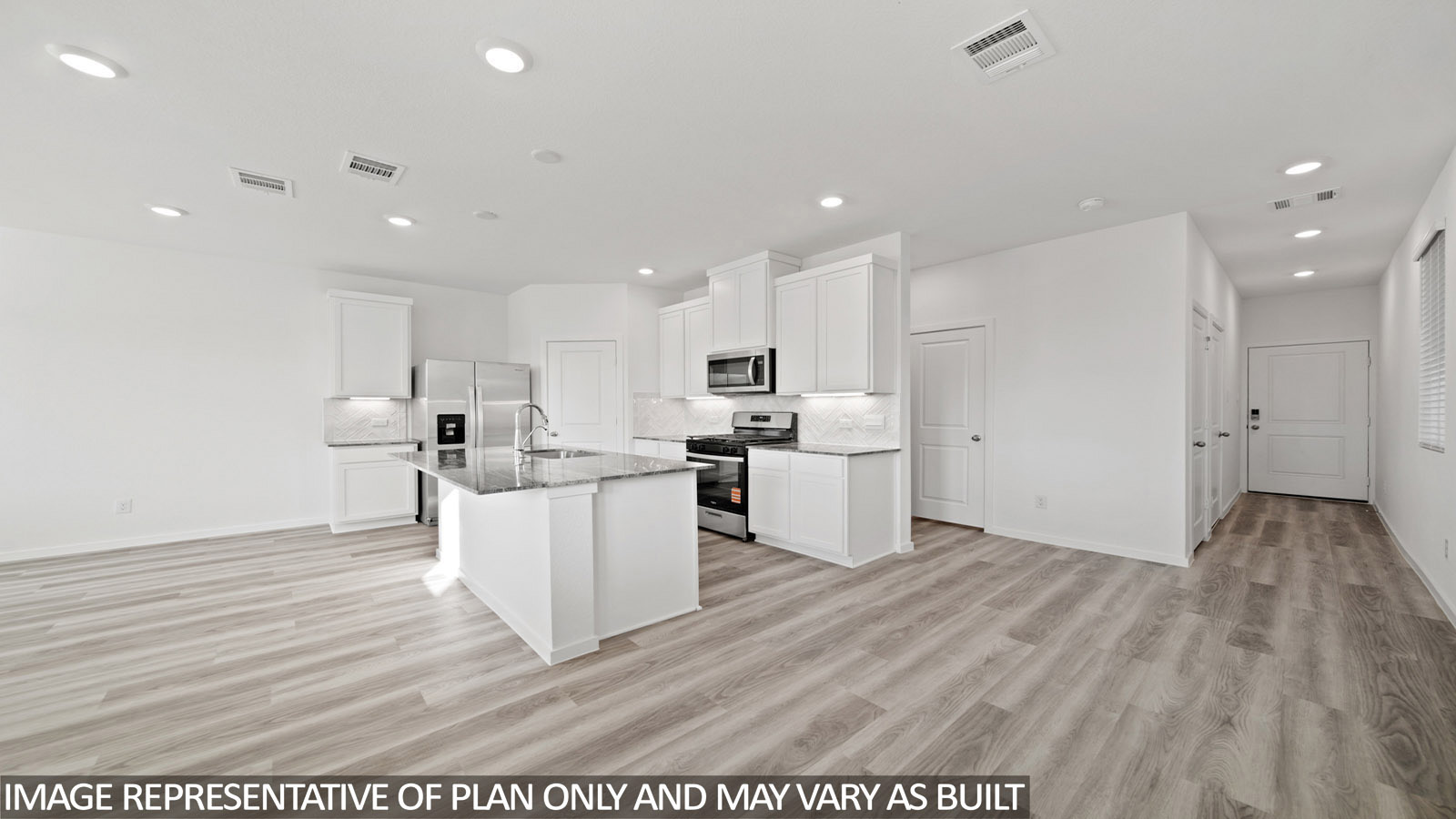 Iris dining room with vinyl plank flooring and view of open concept kitchen and entry way.