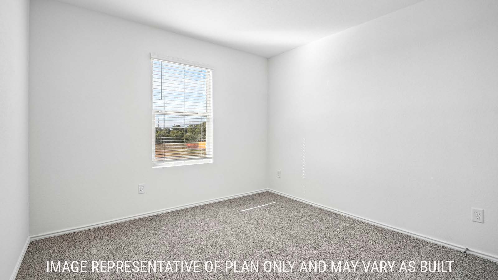 Iris secondary bedroom with carpeted flooring and window for natural lighting.
