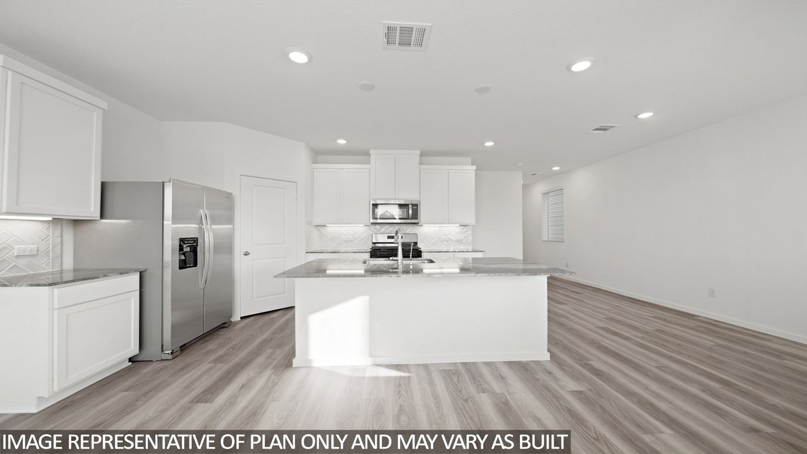Iris kitchen with kitchen island with light cabinets and grey countertops and view of front entry.