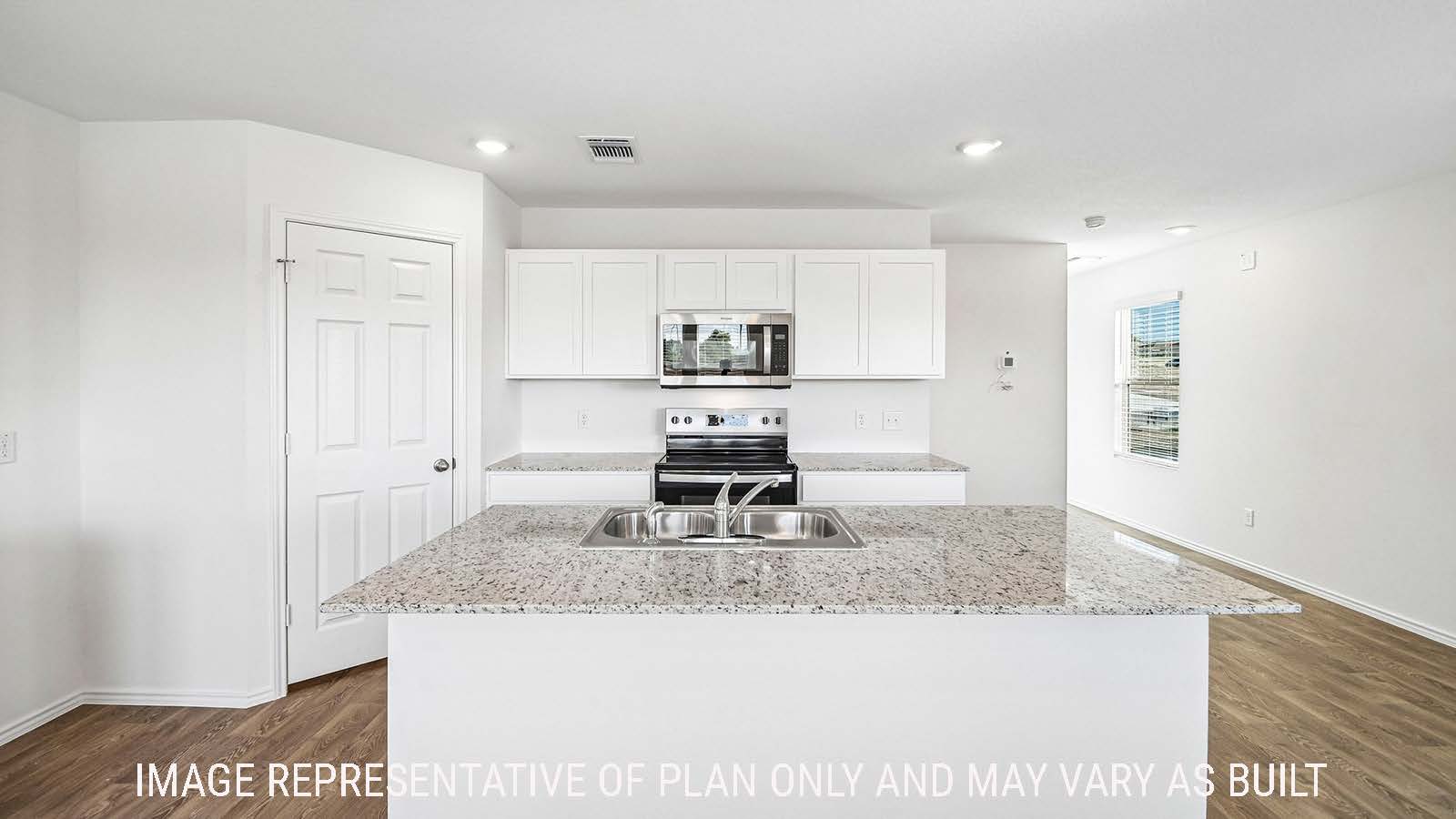 Iris kitchen with kitchen island with white cabinets and granite countertops.