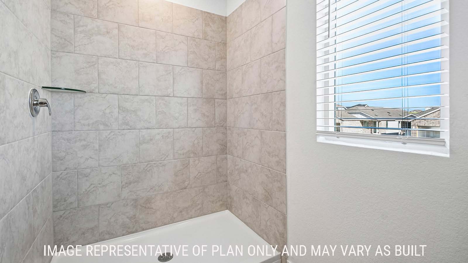 Iris primary bathroom with walk-in shower and window for natural lighting.