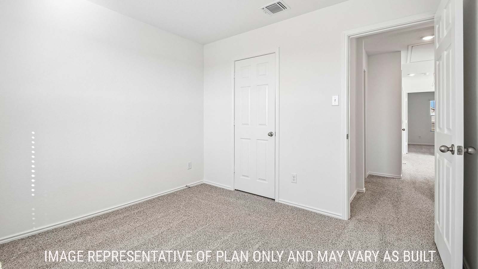 Iris secondary bedroom with carpeted flooring and view of hallway to game room.