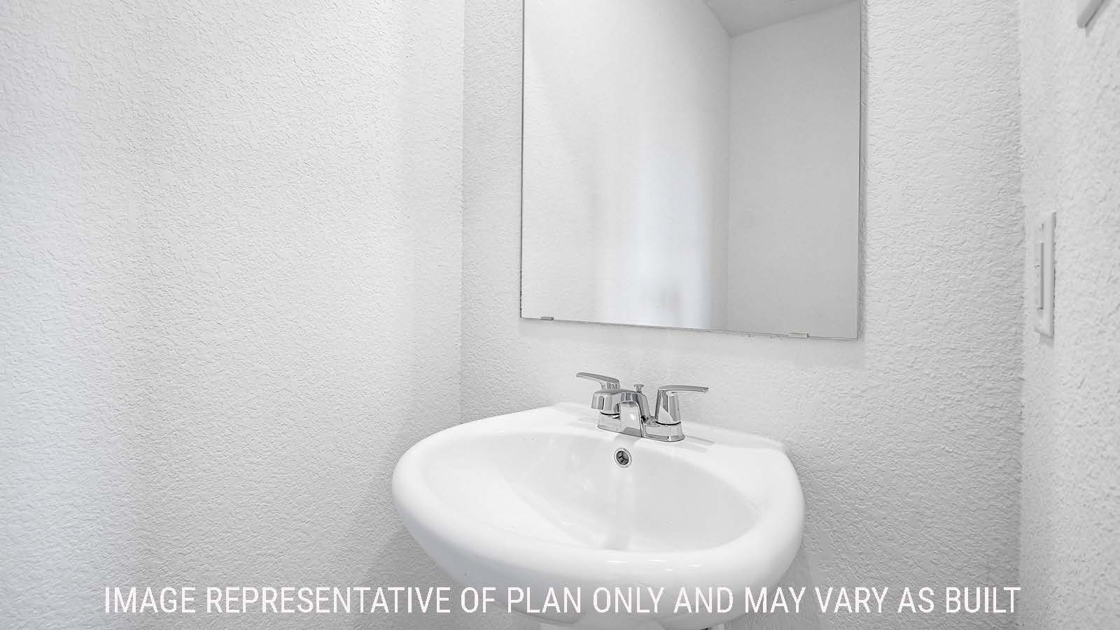 Iris secondary half bathroom with sink and mirror.
