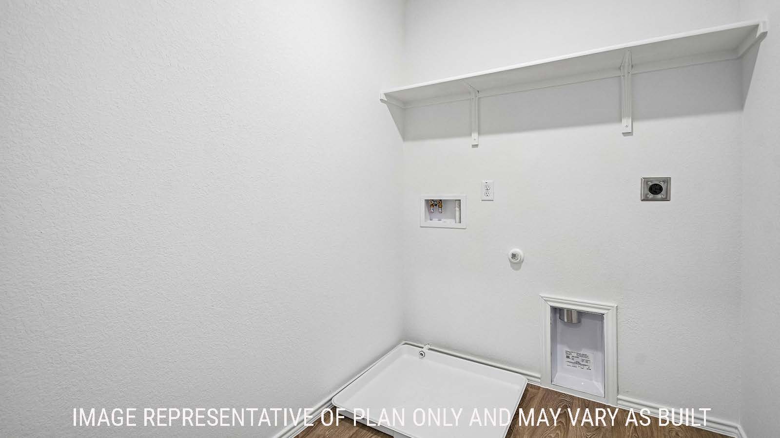 Iris utility room with washer and dryer connections with shelving for storage.