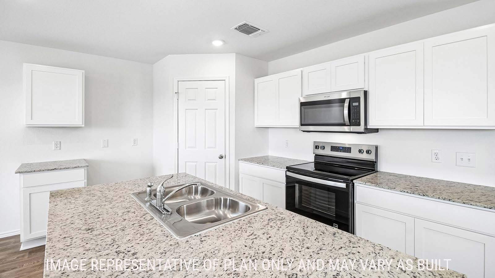 Iris kitchen with kitchen island with white cabinets and granite countertops.