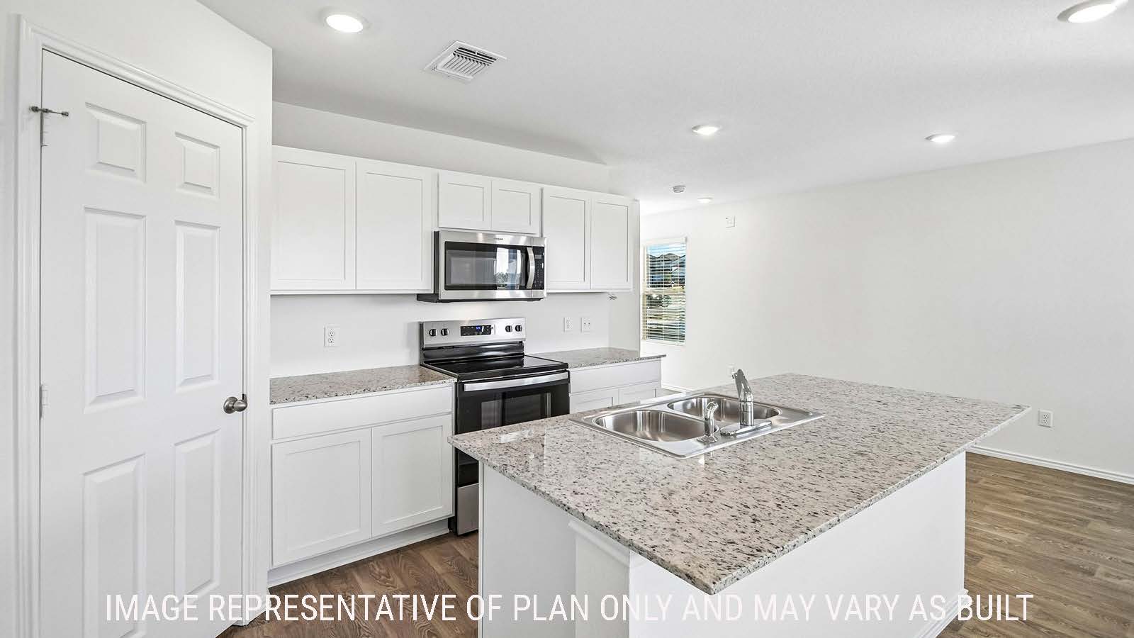 Iris kitchen with kitchen island with white cabinets and granite countertops.