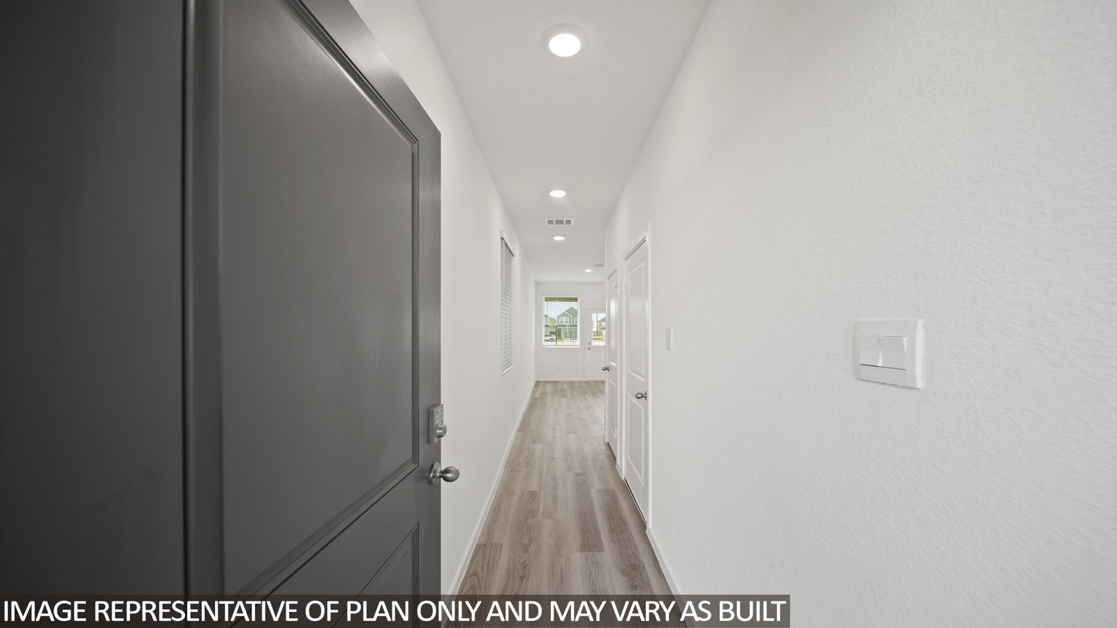 Iris front entry with vinyl plank flooring with view of open concept living room.