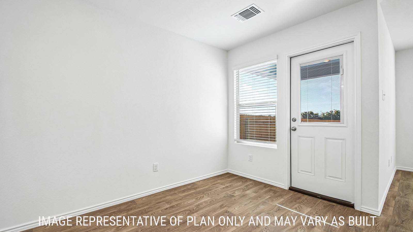 Iris dining room with vinyl flooring with view of back door and back yard.