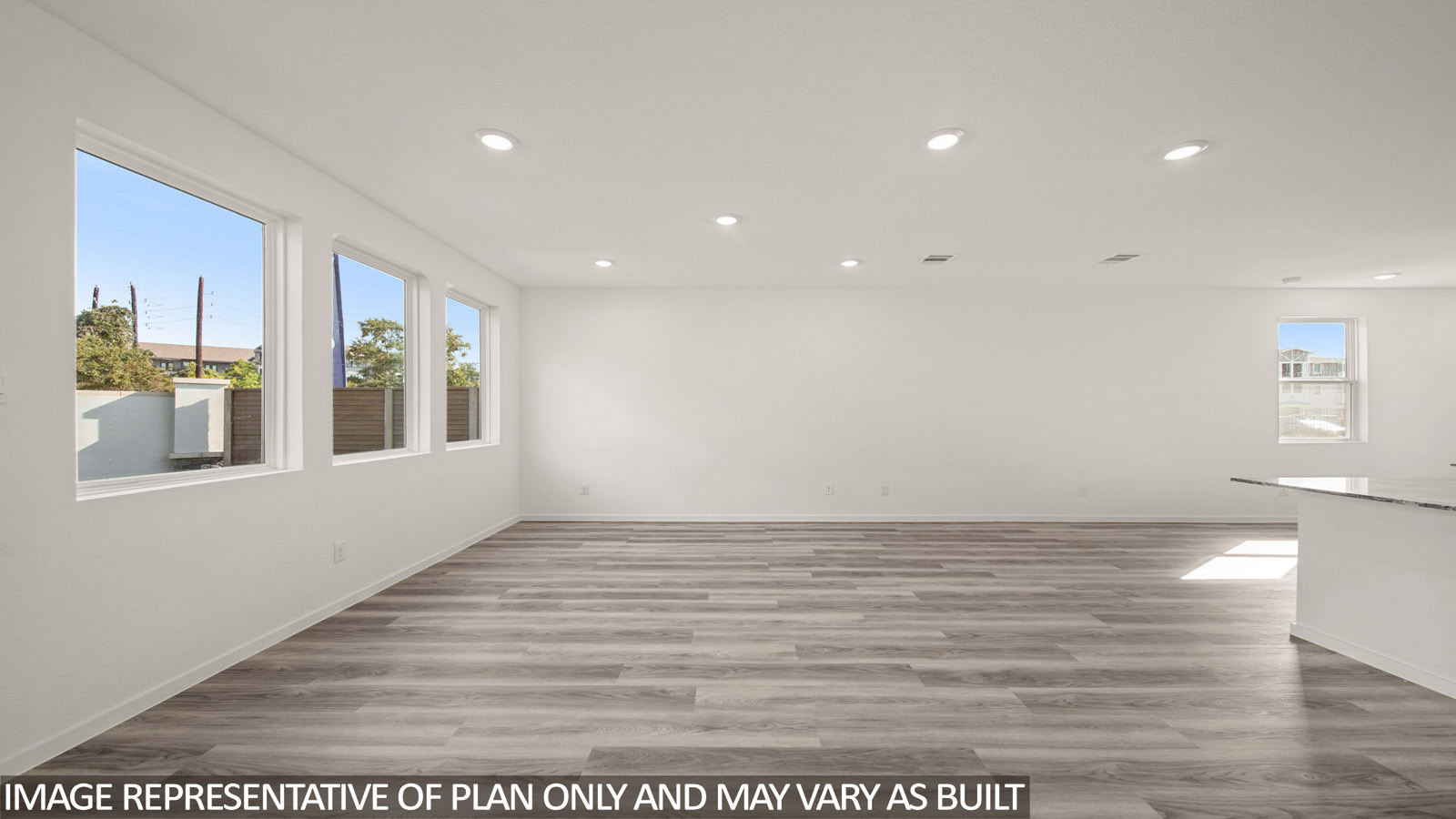 Jasmine living room with vinyl plank flooring and windows for natural lighting.Jasmine living room with vinyl plank flooring and windows for natural lighting.