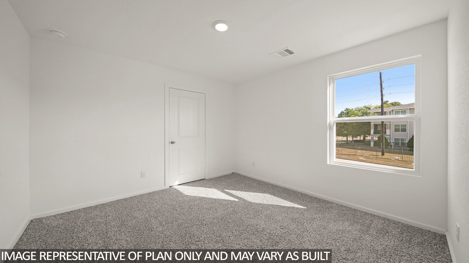 Jasmine secondary bedroom with carpeted flooring and window for natural lighting.