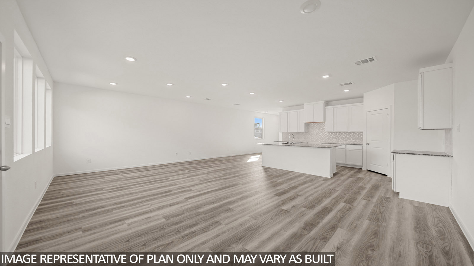 Jasmine dining room with vinyl plank flooring and view of open concept kitchen and living room.