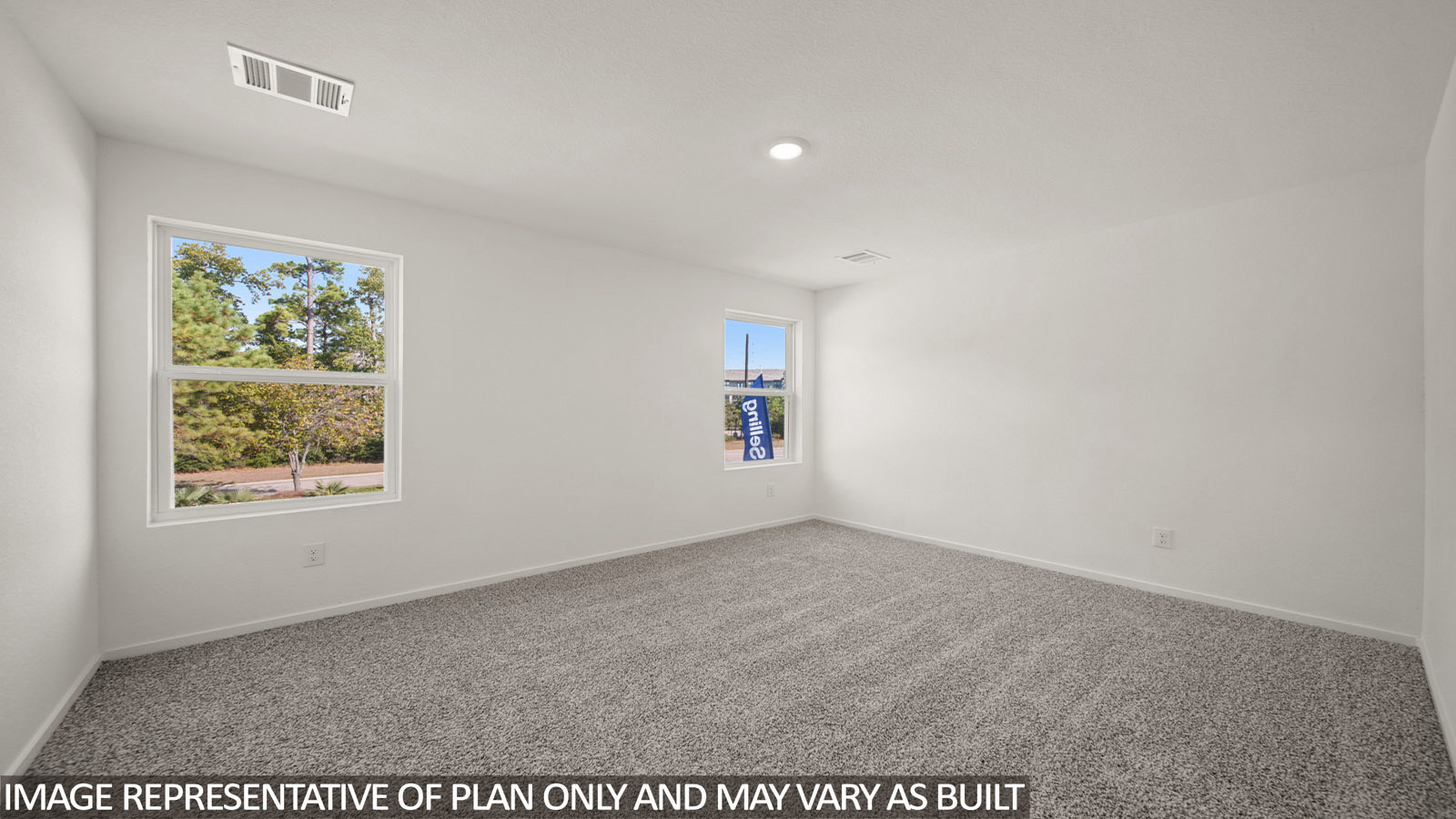 Jasmine primary bedroom with carpeted flooring and windows for natural lighting.