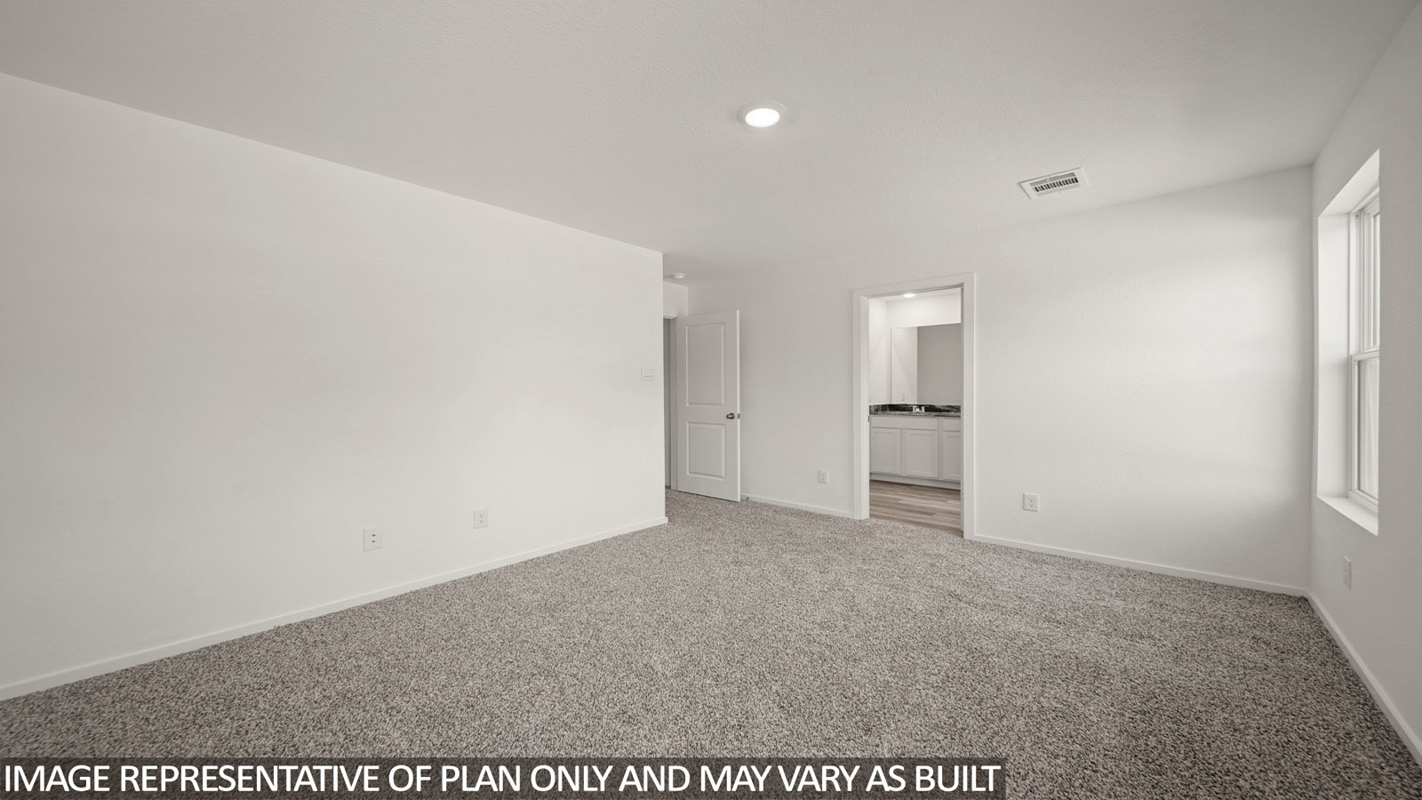 Jasmine primary bedroom with carpeted flooring and view of primary bathroom.
