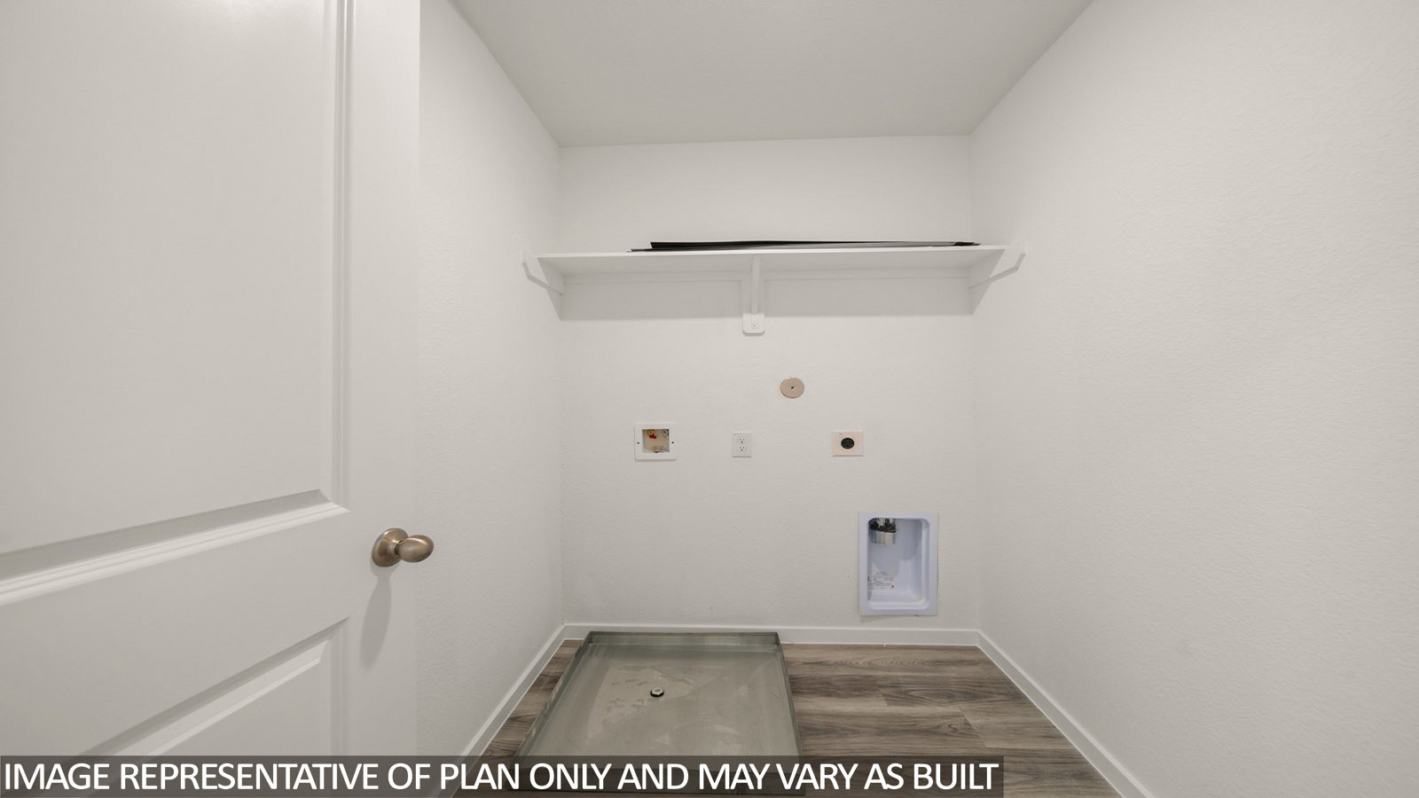 Jasmine utility room with washer and dryer and connections and shelving for storage.