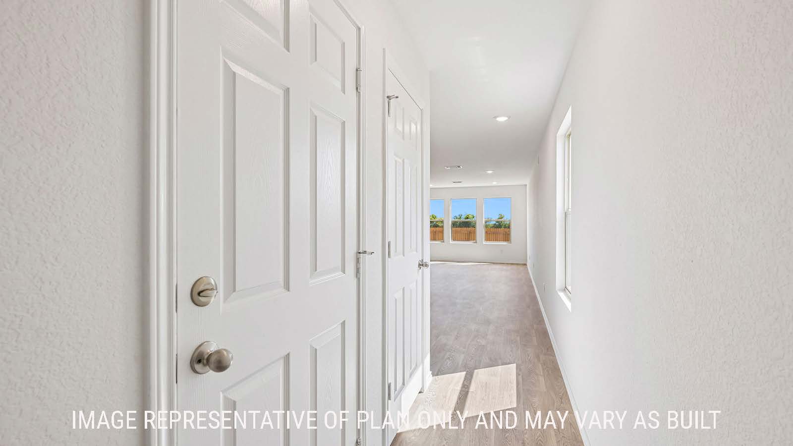Jasmine front entry hallway with view of open concept living room.