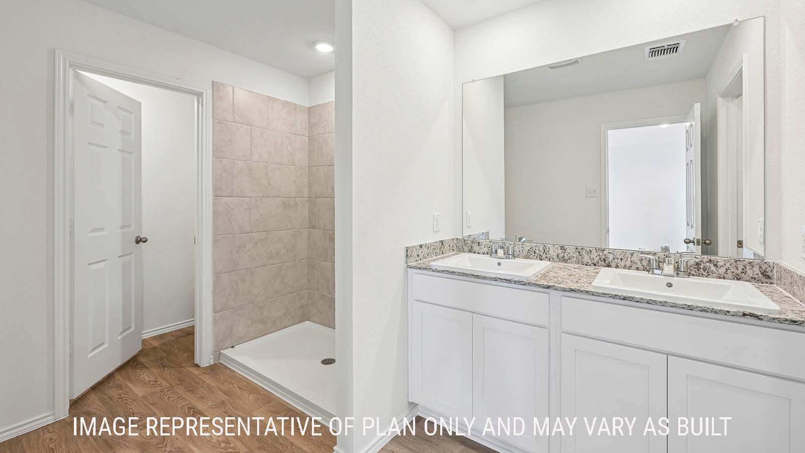 Jasmine primary bathroom with double vanity sink and walk-in shower.