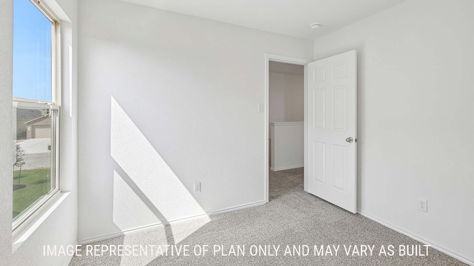 Jasmine secondary bedroom with carpeted flooring and window for natural lighting.