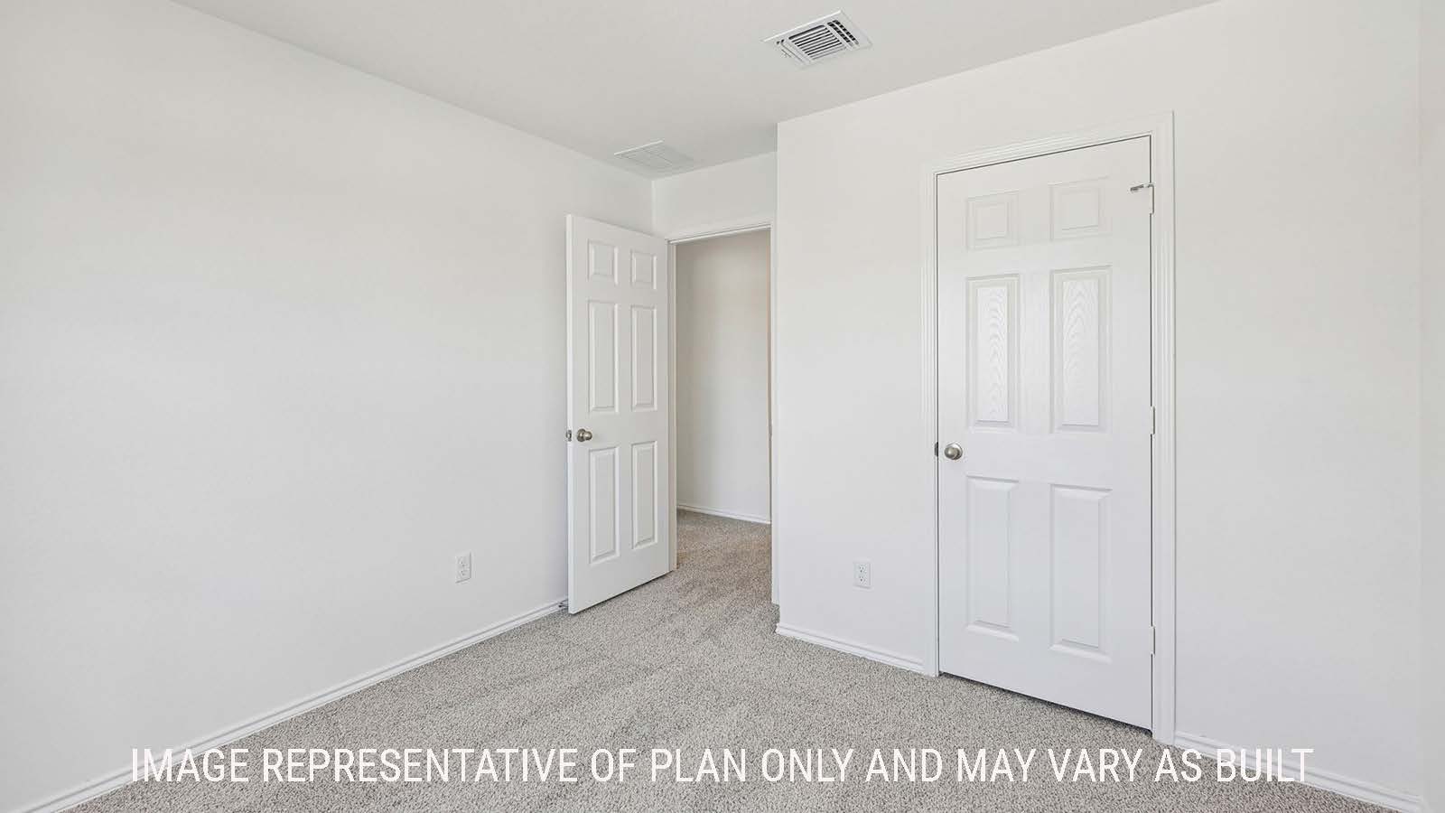 Jasmine secondary bedroom with carpeted flooring and view of hallway.