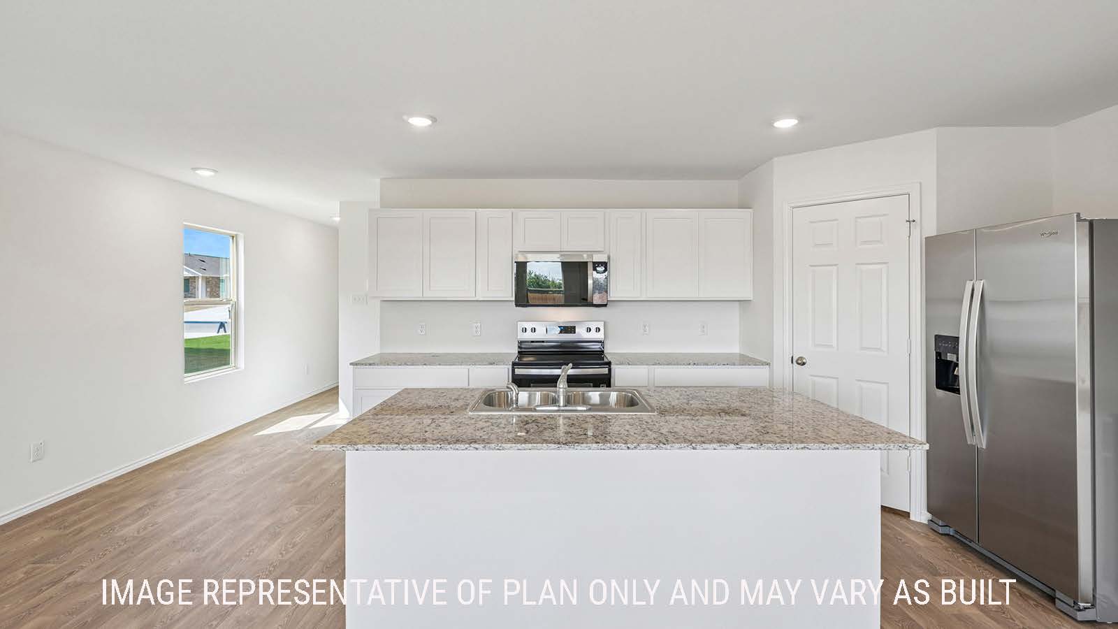 Jasmine kitchen with kitchen island with granite countertops with white cabinets.