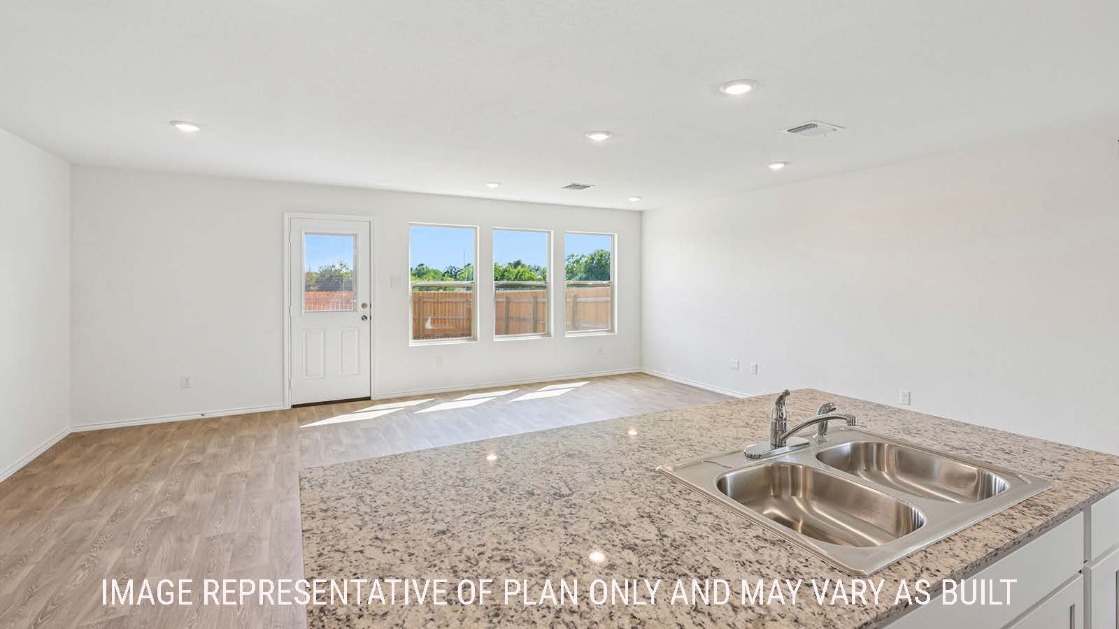 Jasmine kitchen with kitchen island with granite countertops and view of open concept dining room and living room.