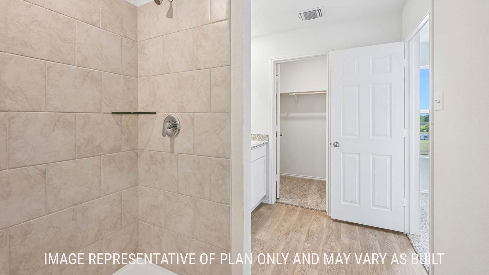 Jasmine primary bathroom with walk-in shower and view of primary bedroom walk-in closet.