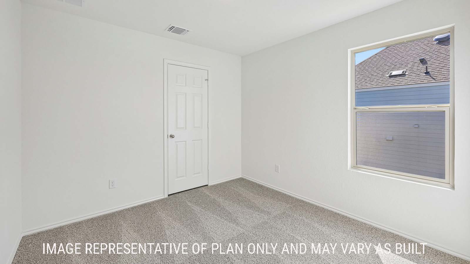 Jasmine secondary bedroom with carpeted flooring and window for natural lighting.