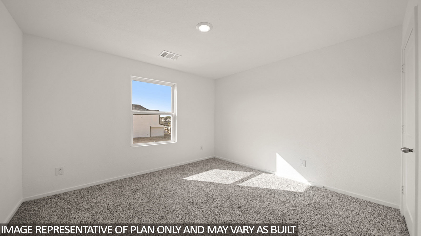 Jasmine secondary bedroom with carpeted flooring and window for natural lighting.