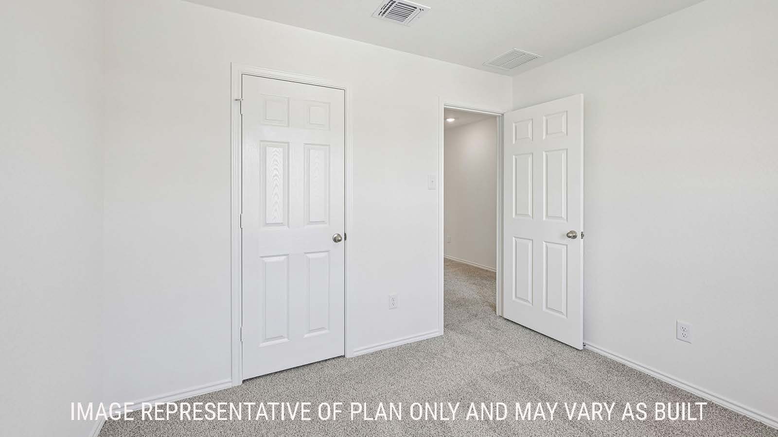 Jasmine secondary bedroom with carpeted flooring and view of hallway.