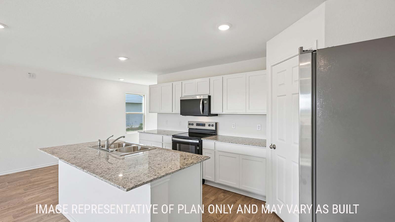 Jasmine kitchen with kitchen island with granite countertops with white cabinets.