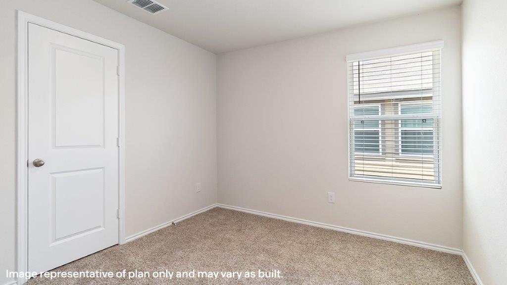 Barton secondary bedroom with carpeted flooring and window.