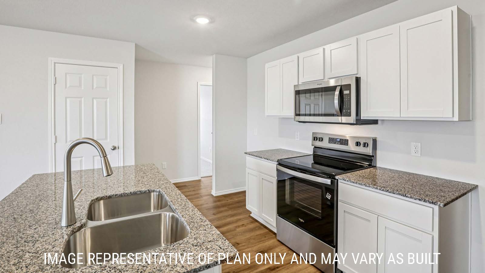 Estero kitchen with kitchen island with granite countertops and white cabinets.