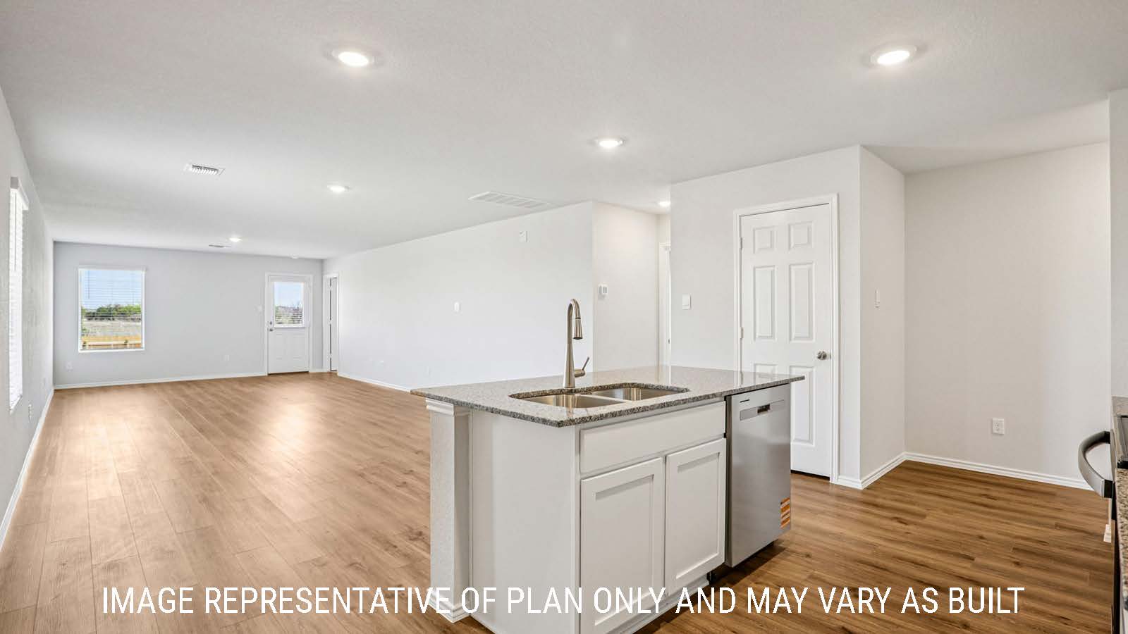 Estero kitchen with granite countertops with view of open concept dining room and living room.