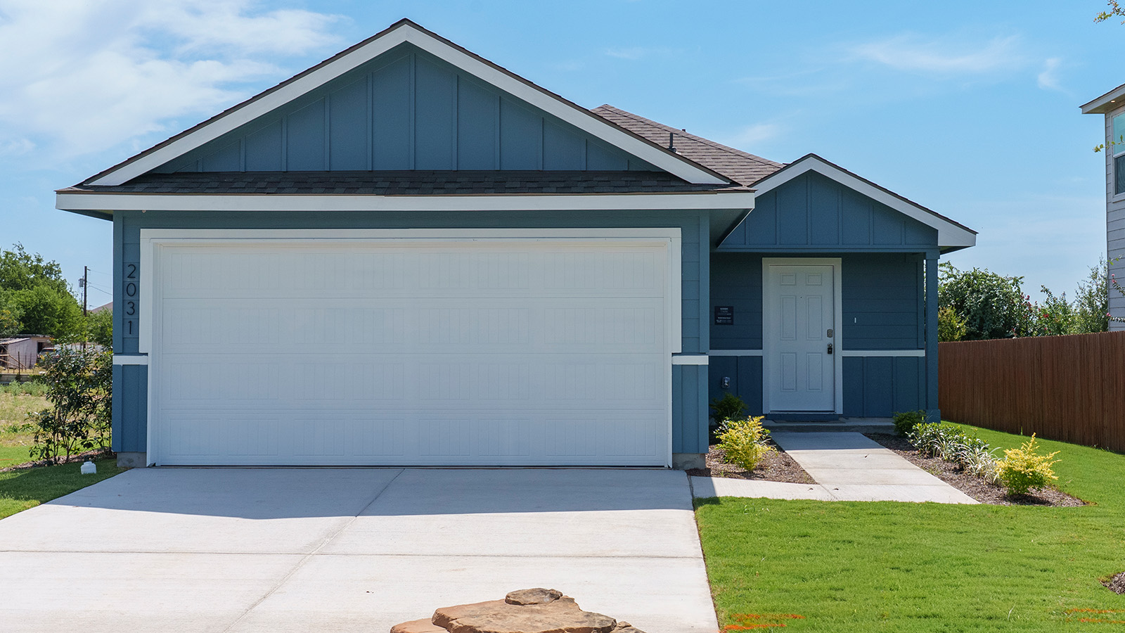 Hidden Trails Model Home front exterior with landscaping.