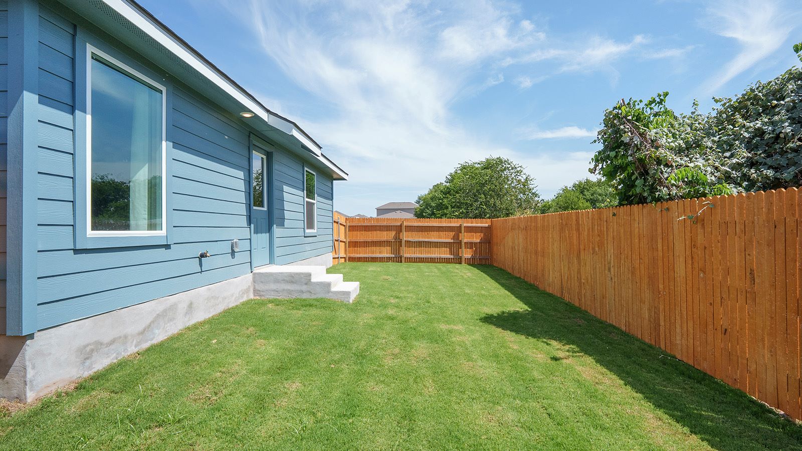 Hidden Trails Model Home back exterior with landscaping.