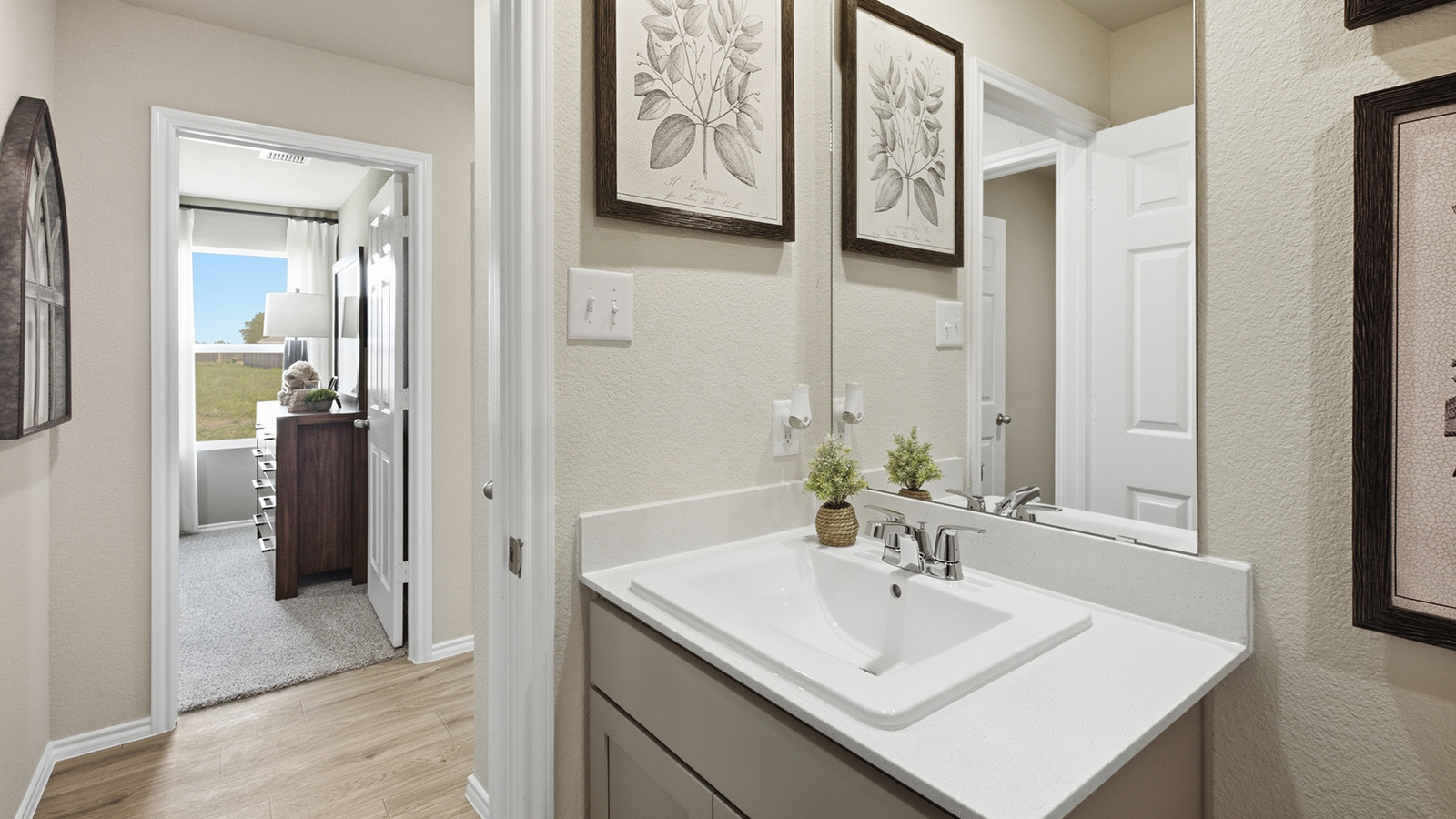 Hidden Trails Model Home secondary bathroom  with vanity sink and view of hallway.