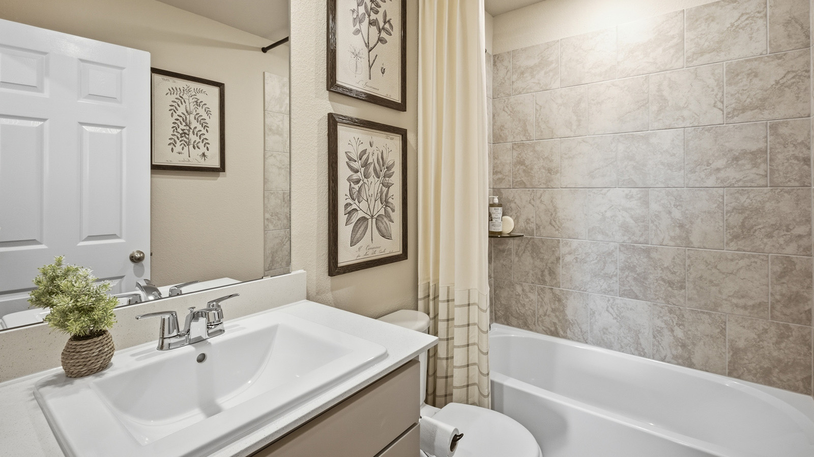 Hidden Trails Model Home secondary bathroom with vanity sink and shower and tub combo.
