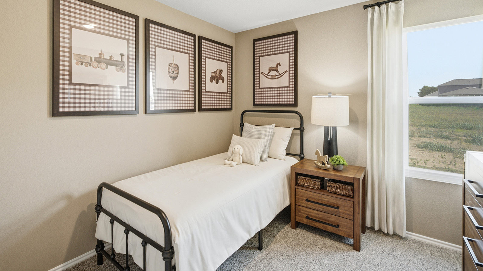 Hidden Trails Model Home secondary bedroom with carpeted flooring and window for natural lighting.