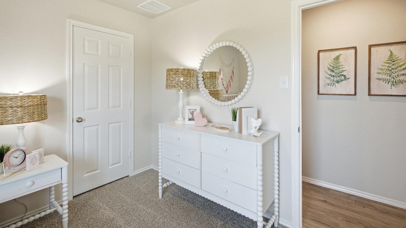 Hidden Trails Model Home secondary bedroom with carpeted flooring and view of hallway.