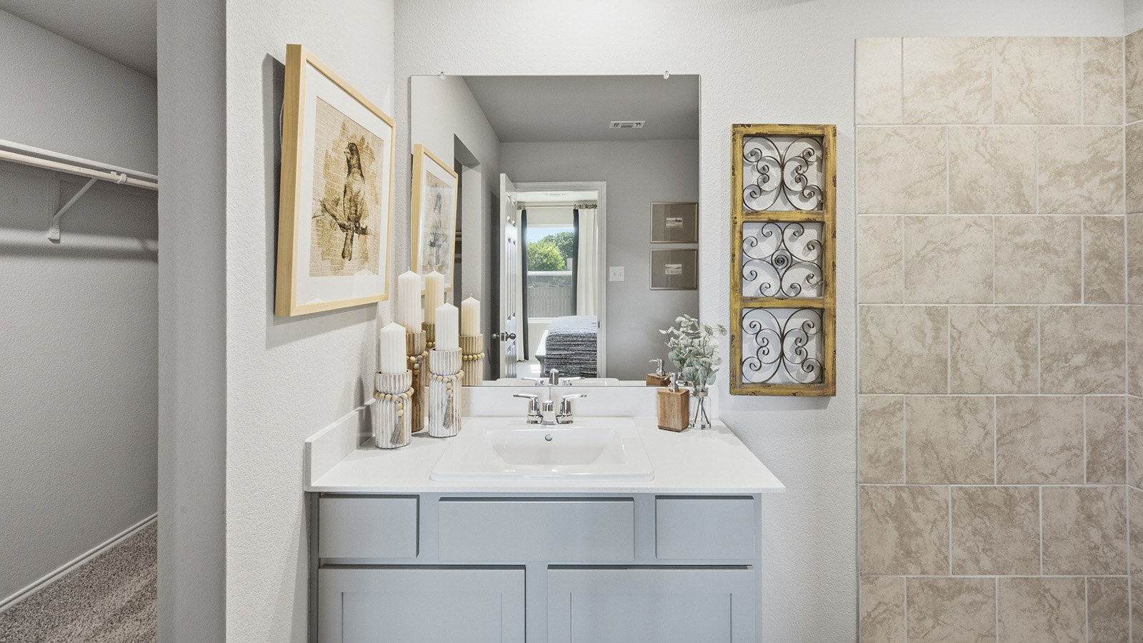 Hidden Trails Model Home primary bathroom with vanity sink and view of primary walk-in closet.