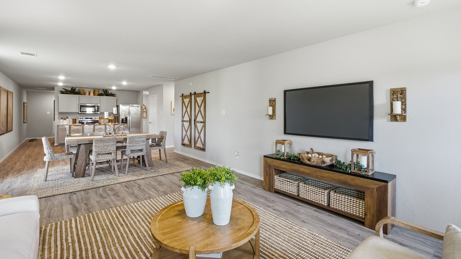 Hidden Trails Model Home living room with view of open concept dining room and kitchen.