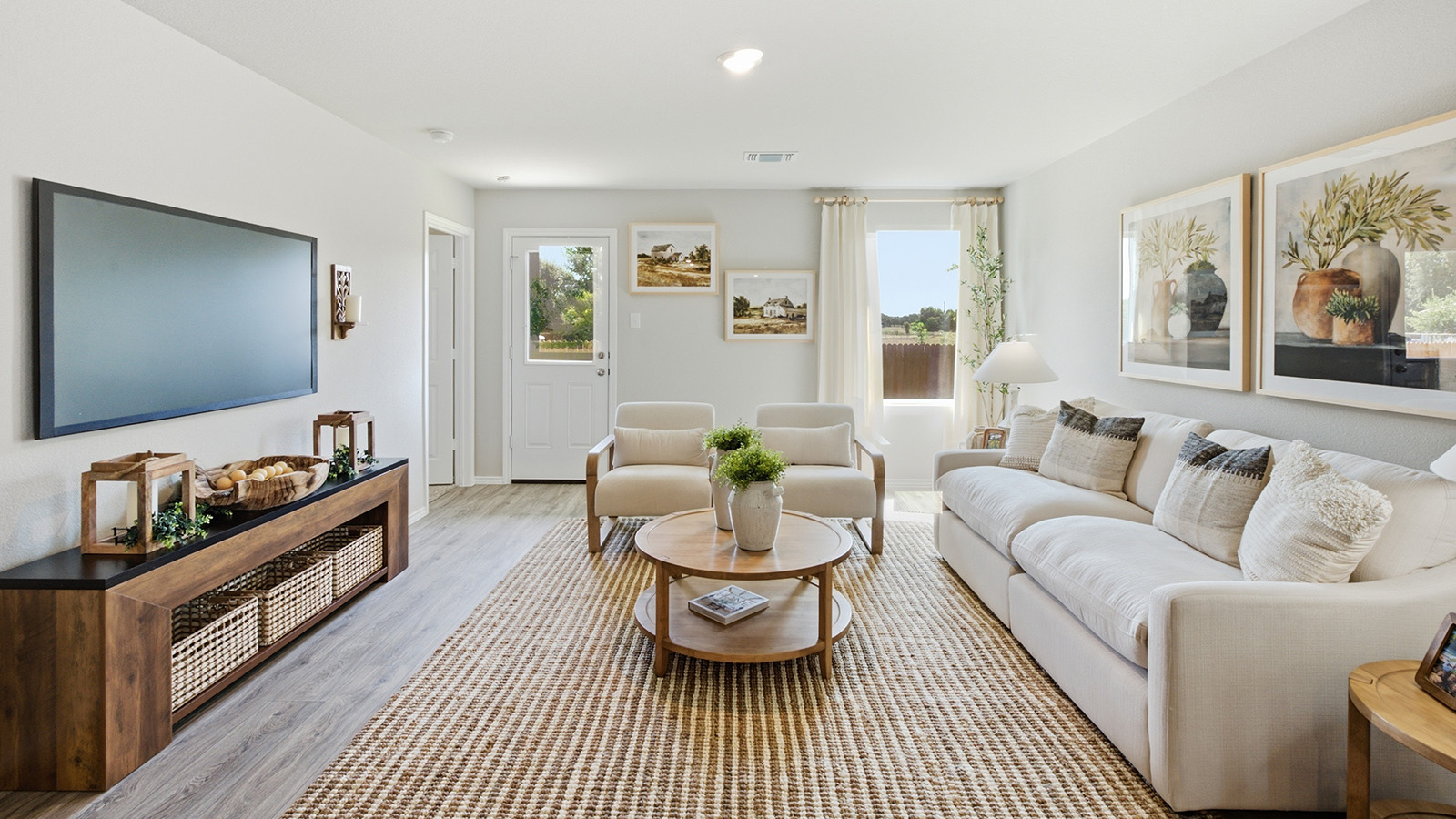 Hidden Trails Model Home living room with windows for natural lighting and view of back yard.