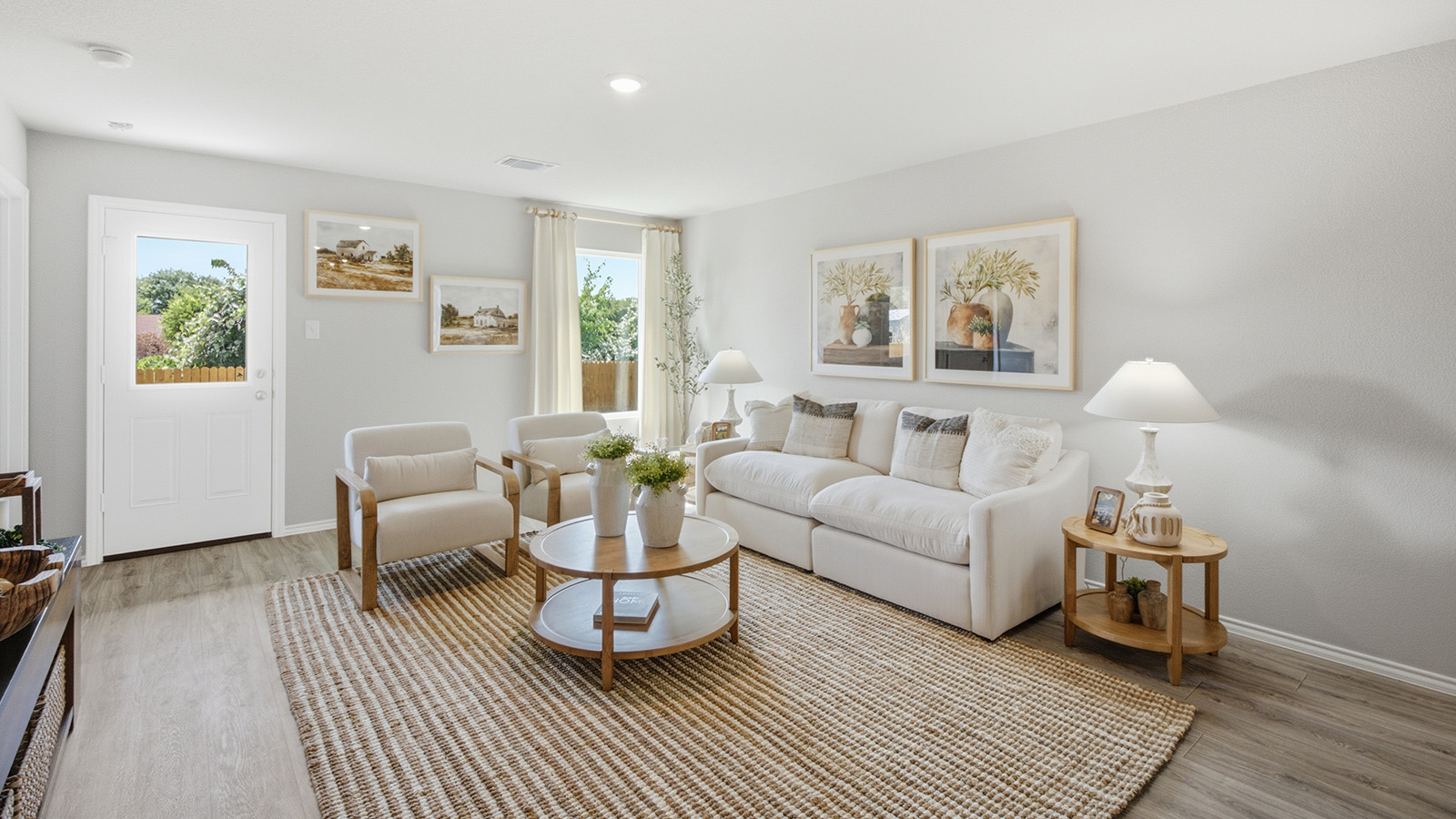 Hidden Trails Model Home living room with windows for natural lighting and view of back yard.