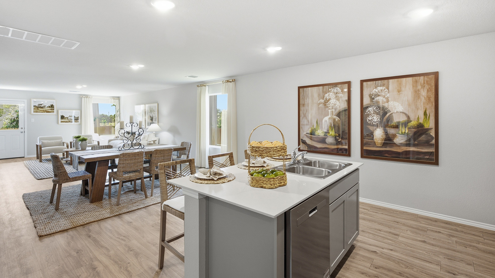Hidden Trails Model Home kitchen with kitchen island and view of open concept dining room and living room.