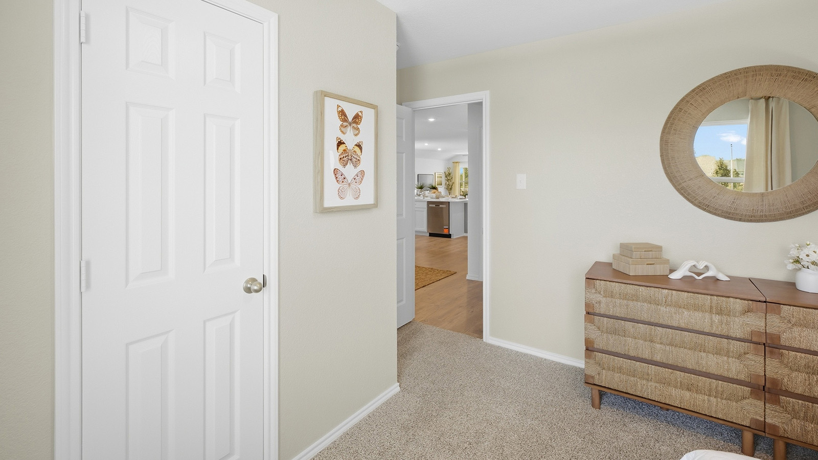 Wildwood Model secondary bedroom with carpeted flooring and view of hallway.