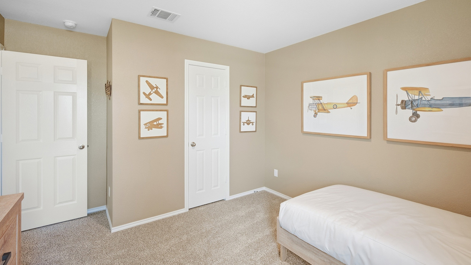 Wildwood Model secondary bedroom with carpeted flooring and view of hallway.
