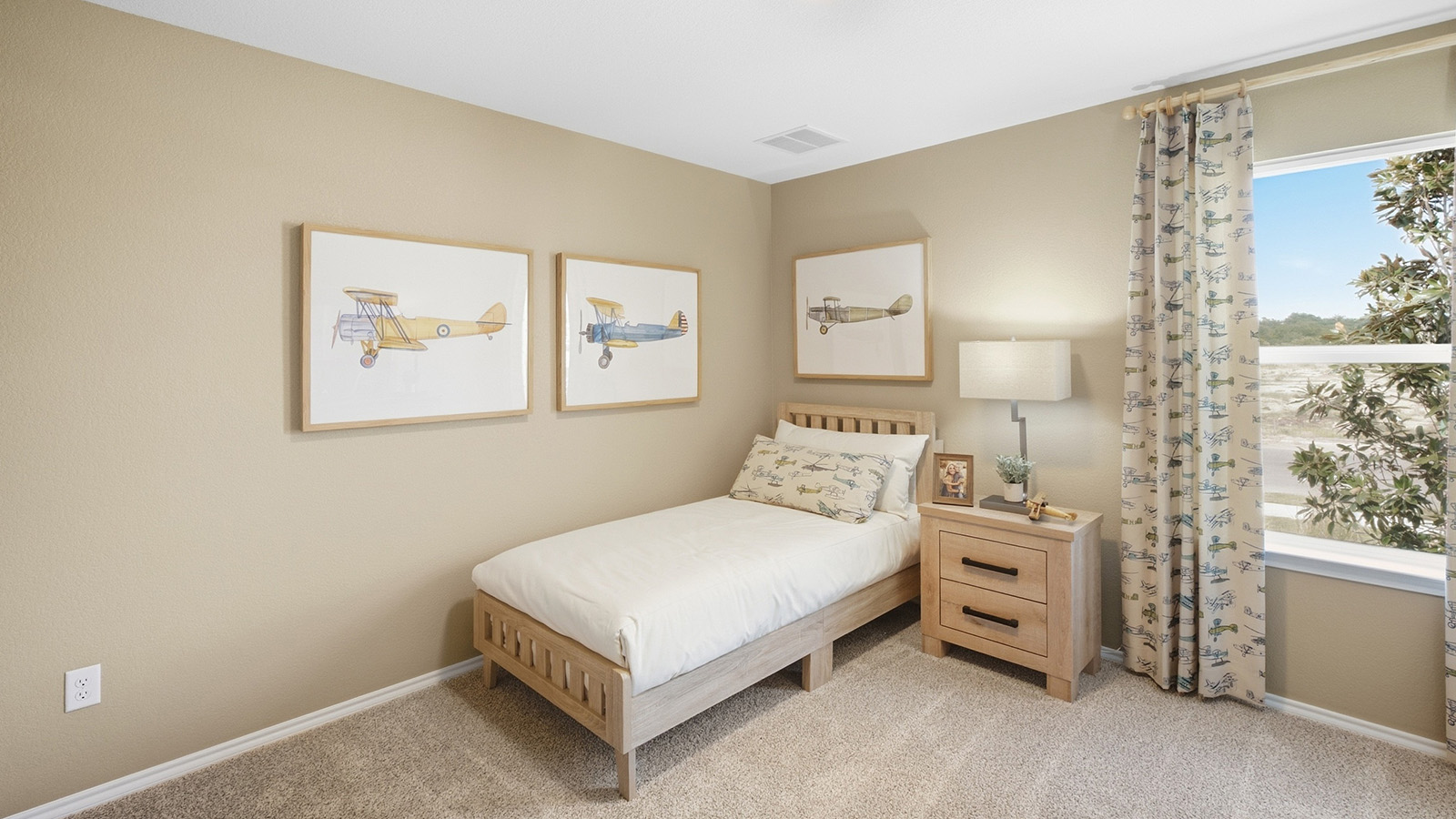Wildwood Model secondary bedroom with carpeted flooring and windows for natural lighting.