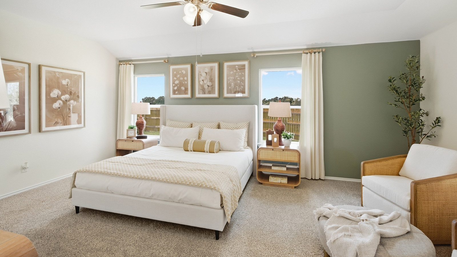 Wildwood Model primary bedroom with carpeted flooring and windows for natural lighting.