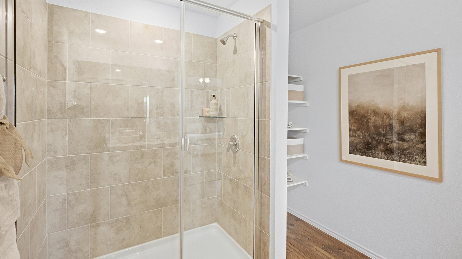 Wildwood Model primary bathroom with walk-in shower and shelving for storage.