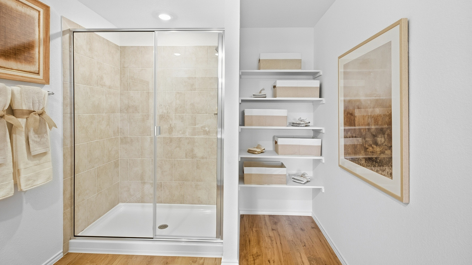 Wildwood Model primary bathroom with walk-in shower and shelving for storage.