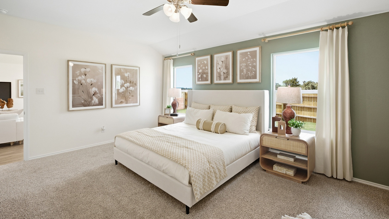 Wildwood Model primary bedroom with carpeted flooring and view of primary bathroom.